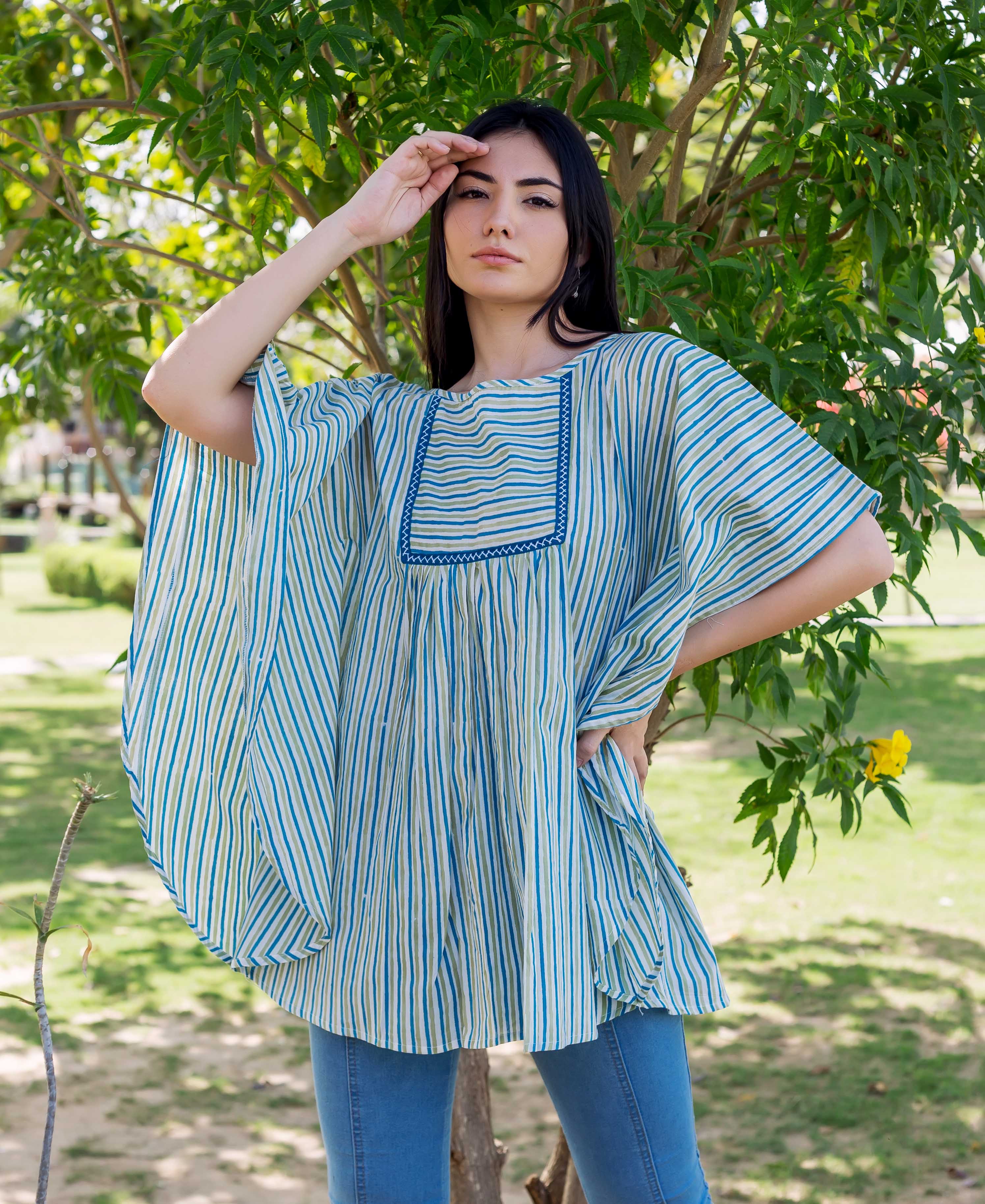 Front view model in blue and green striped block printed kaftan top and jeans.