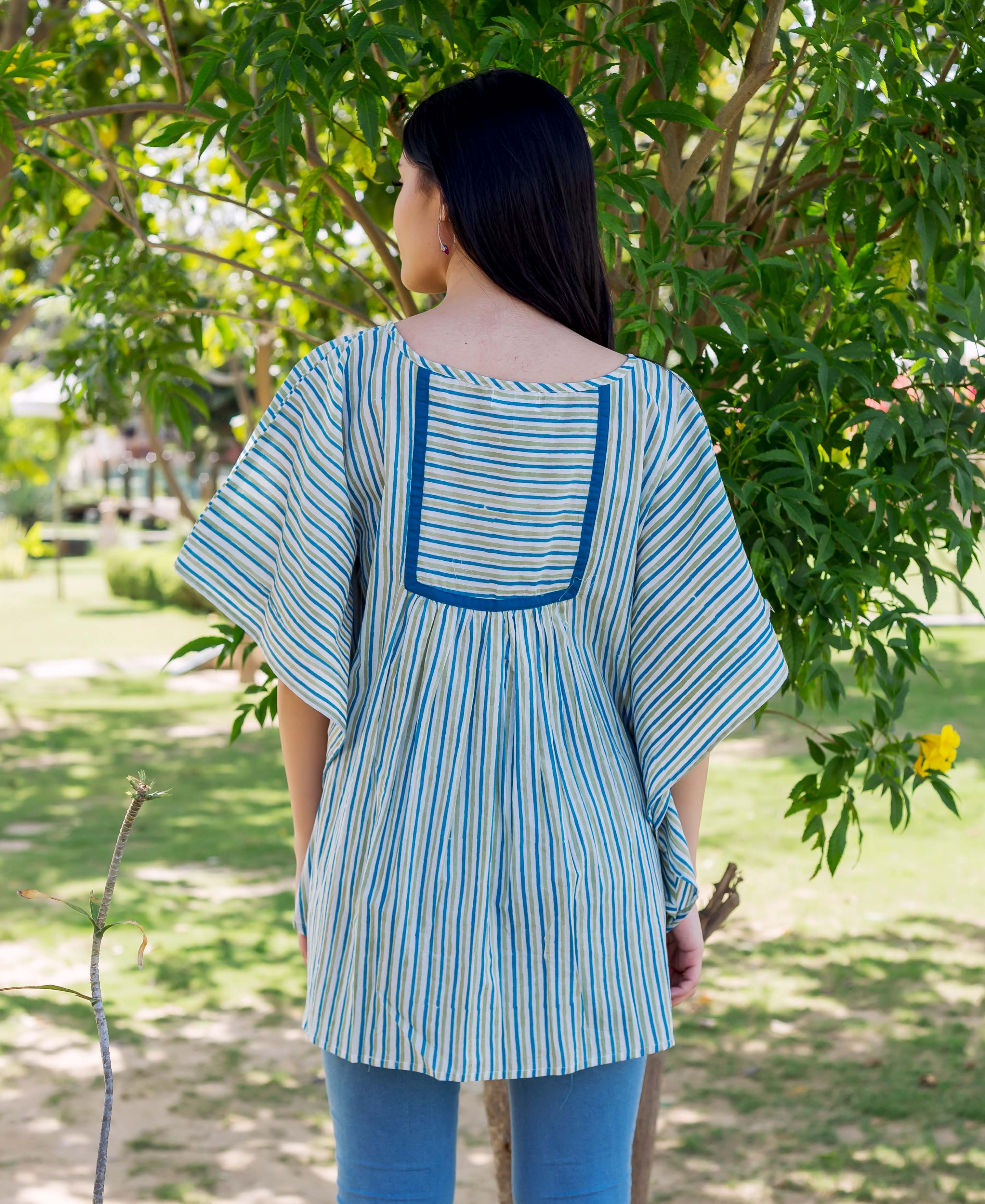 Rear view of model in blue, green striped block print kaftan top with square yoke.