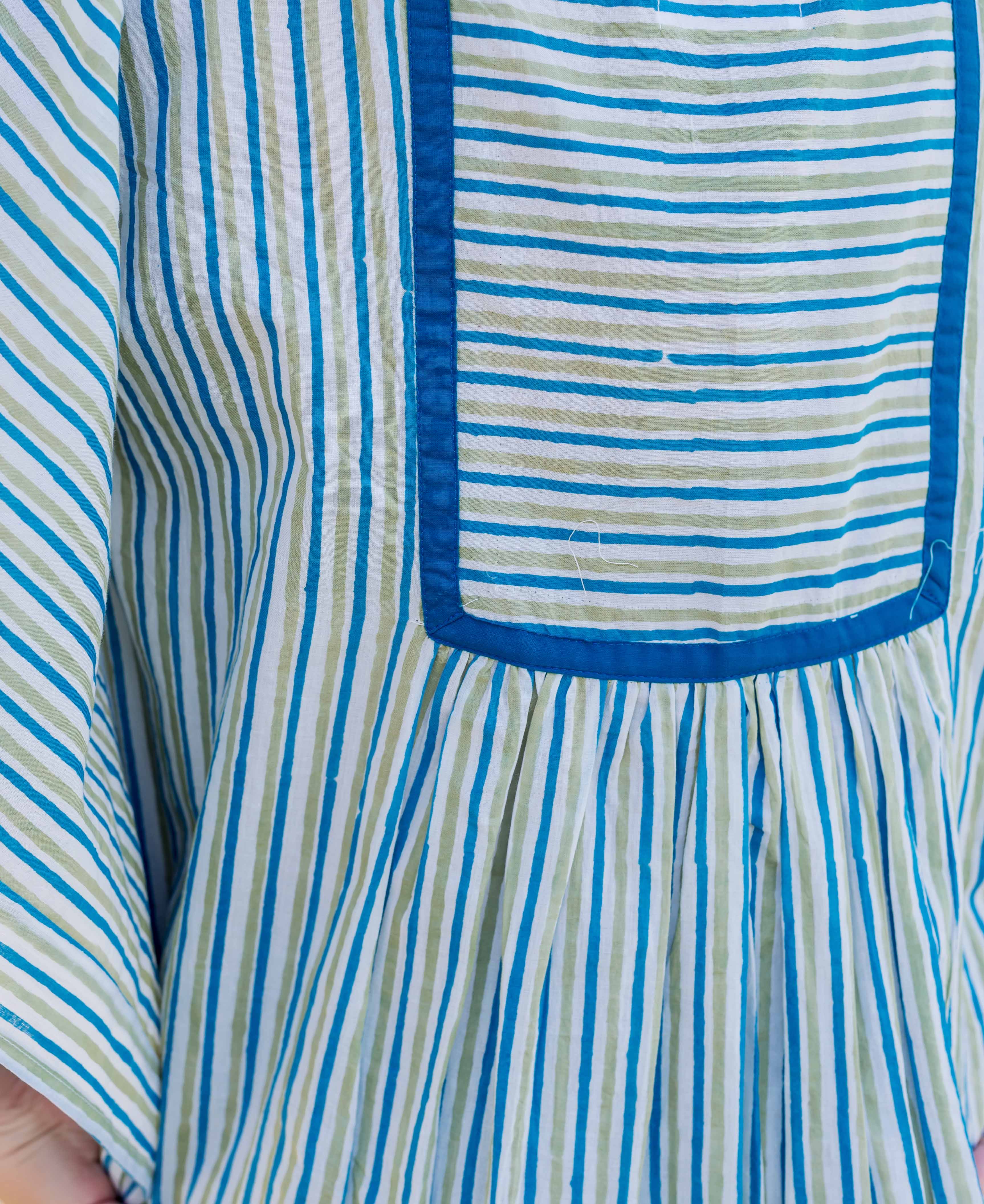 Front close-up of blue and green striped block-printed kaftan top with square yoke.