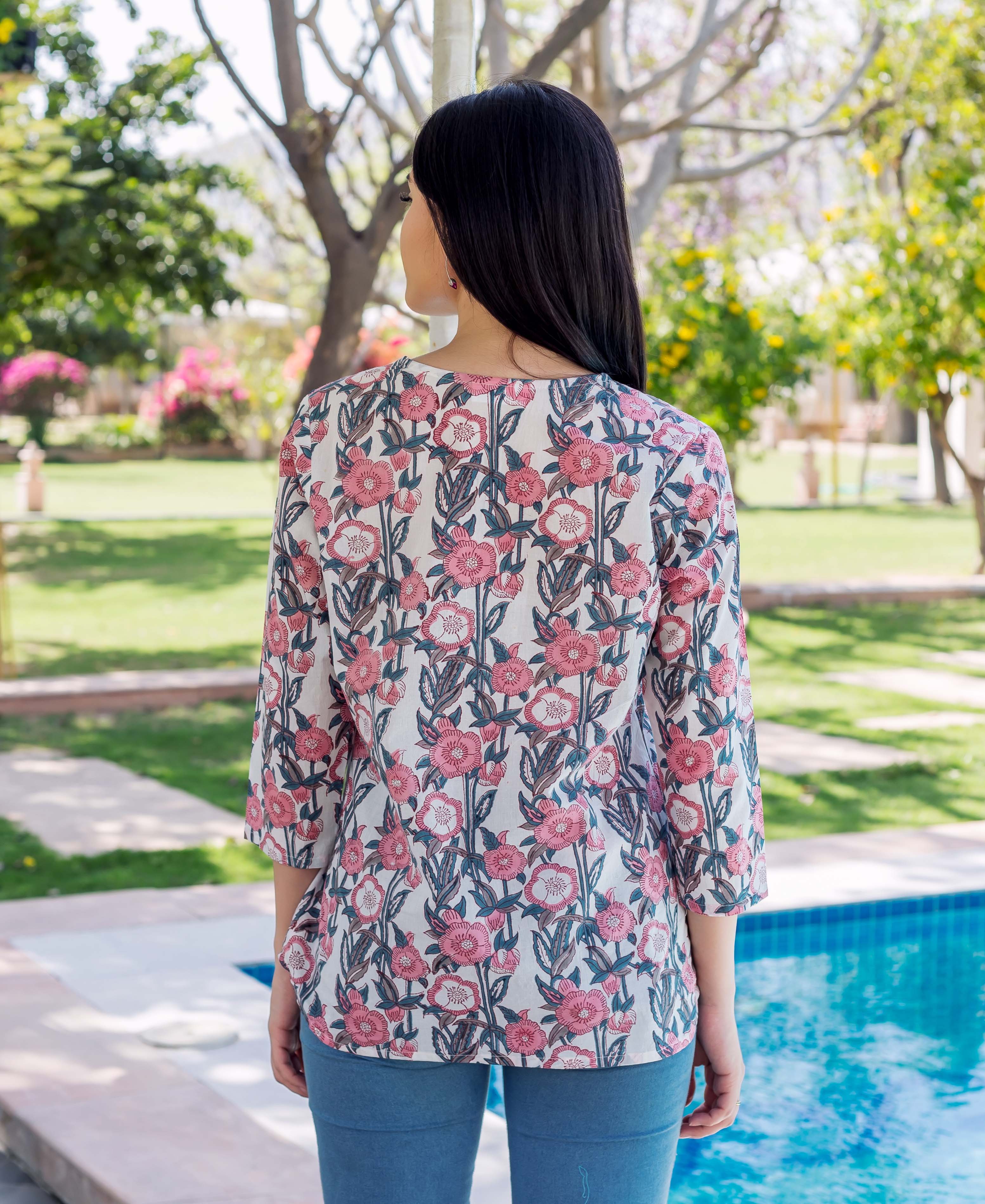 Grey and pink block printed Noya Top on a model, back view.