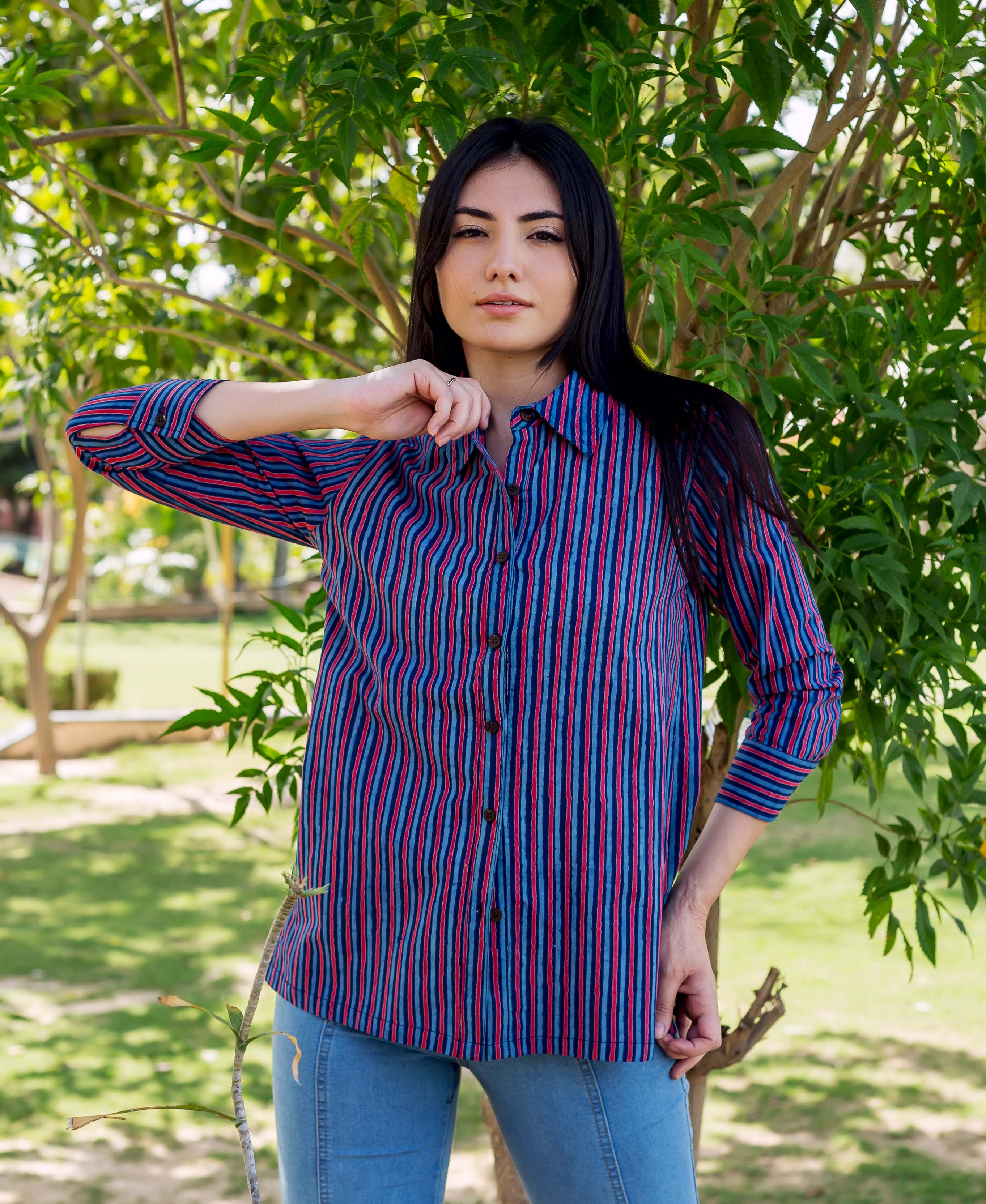 Front-facing model wearing an Indigo and Red striped Kiara shirt with light blue jeans.