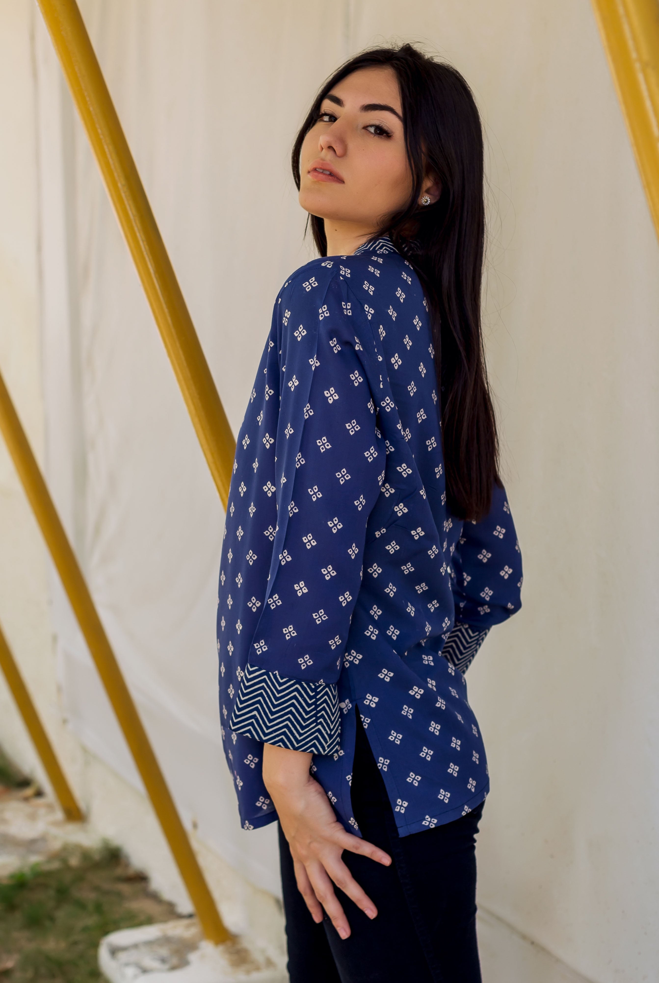 Model in indigo Bandhej printed top, side view, showing distinctive patterned sleeve cuff.