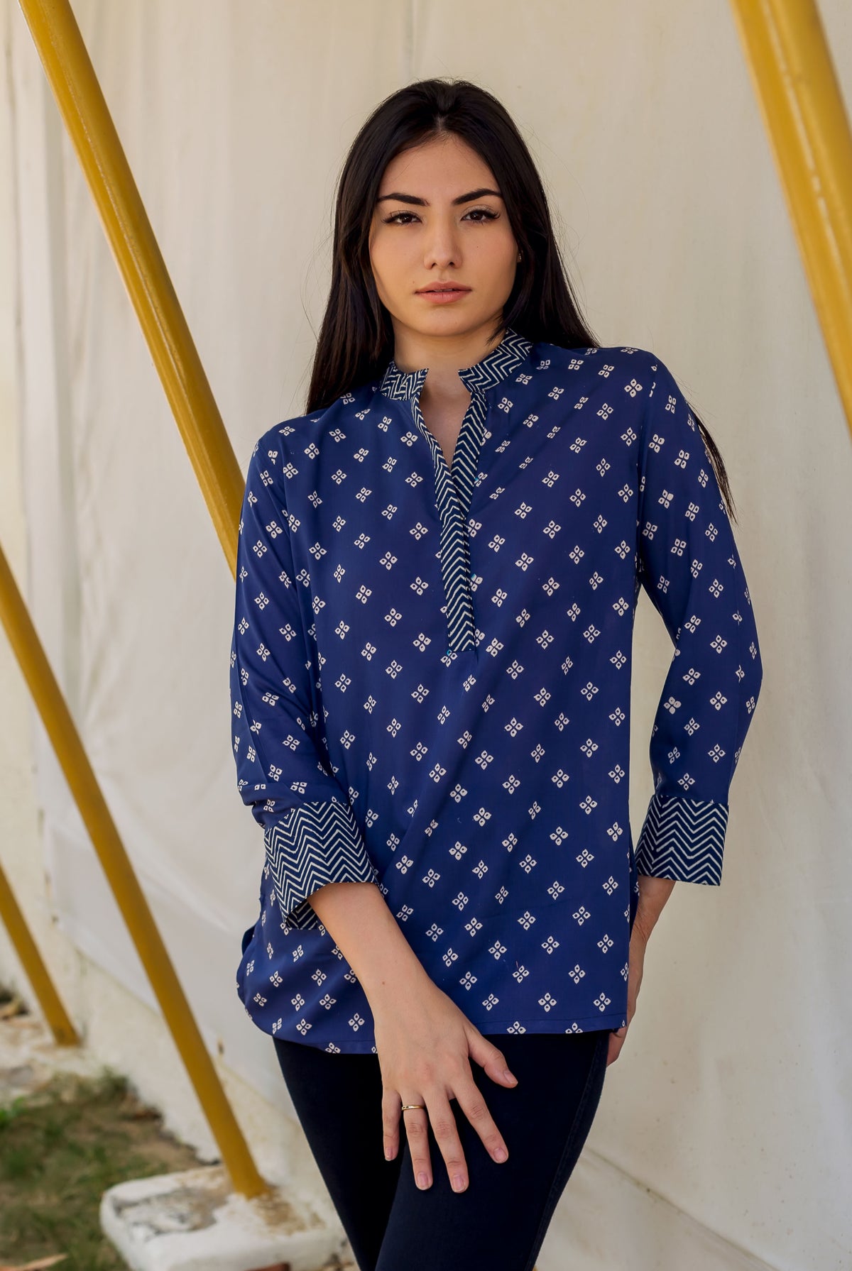 Model wearing indigo Bandhej print modal top with stand collar and patterned cuffs.
