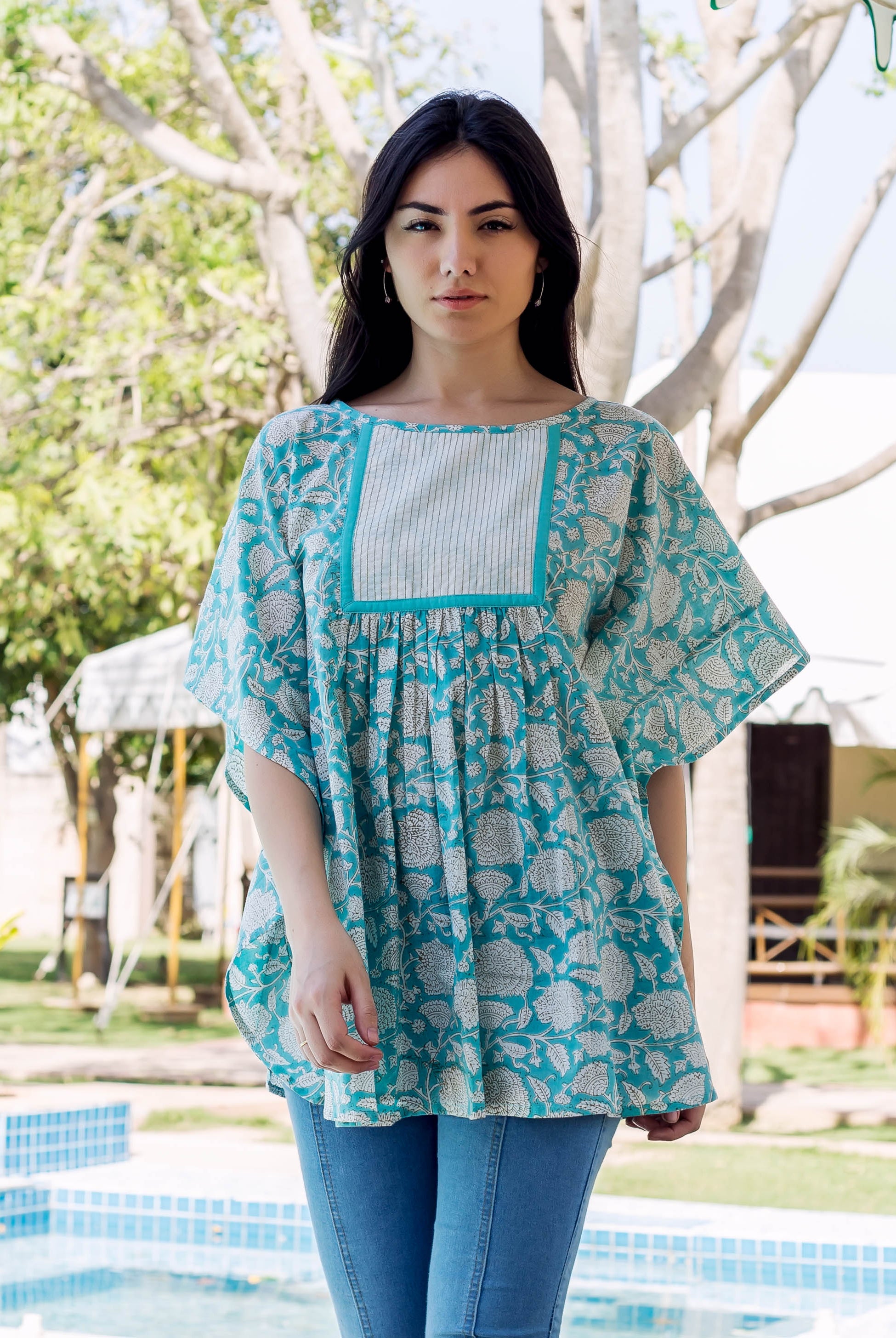 Model wearing sea blue floral block-printed kaftan top with a striped chest panel.
