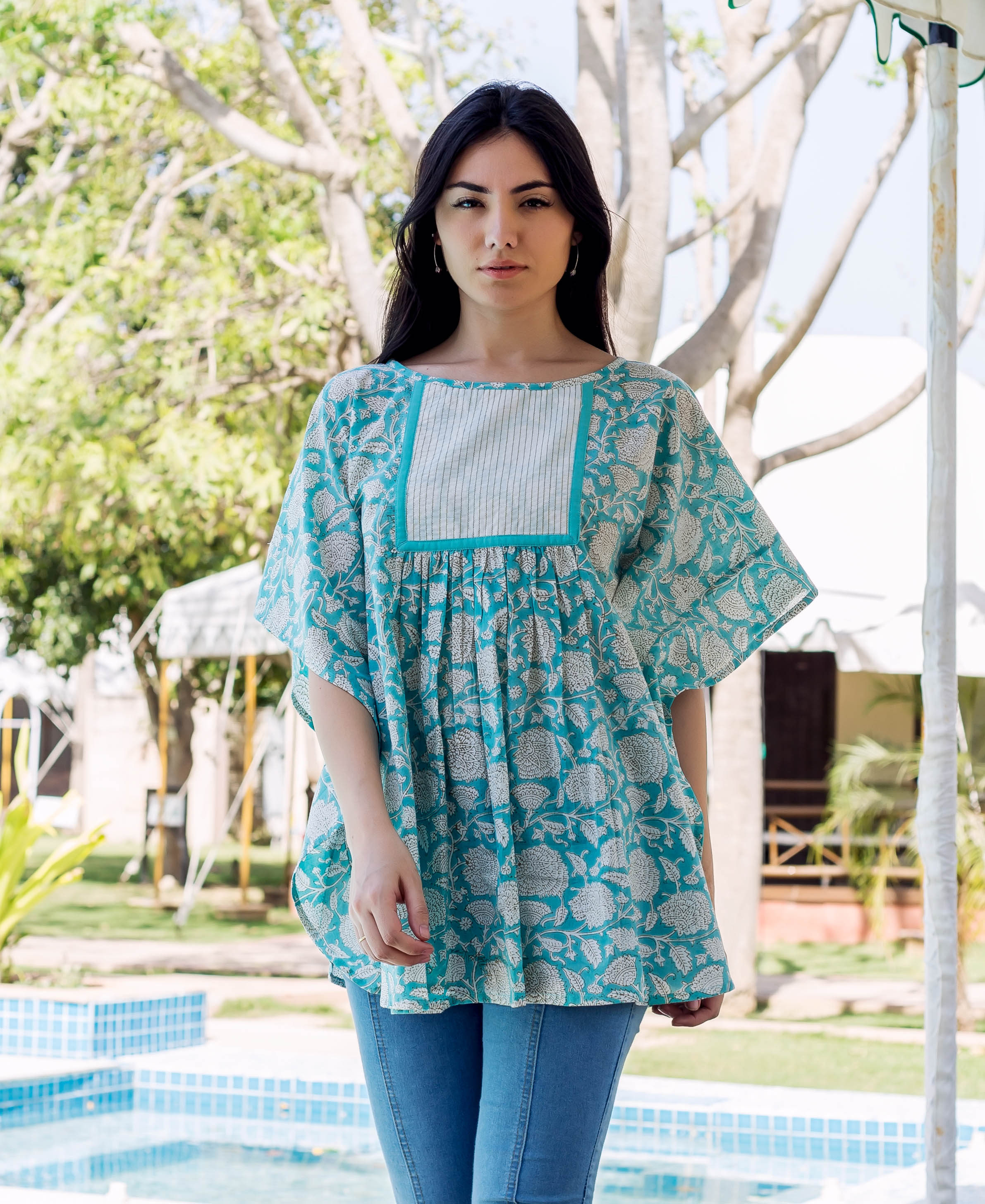 Model wearing sea blue floral block-printed kaftan top with a striped chest panel.