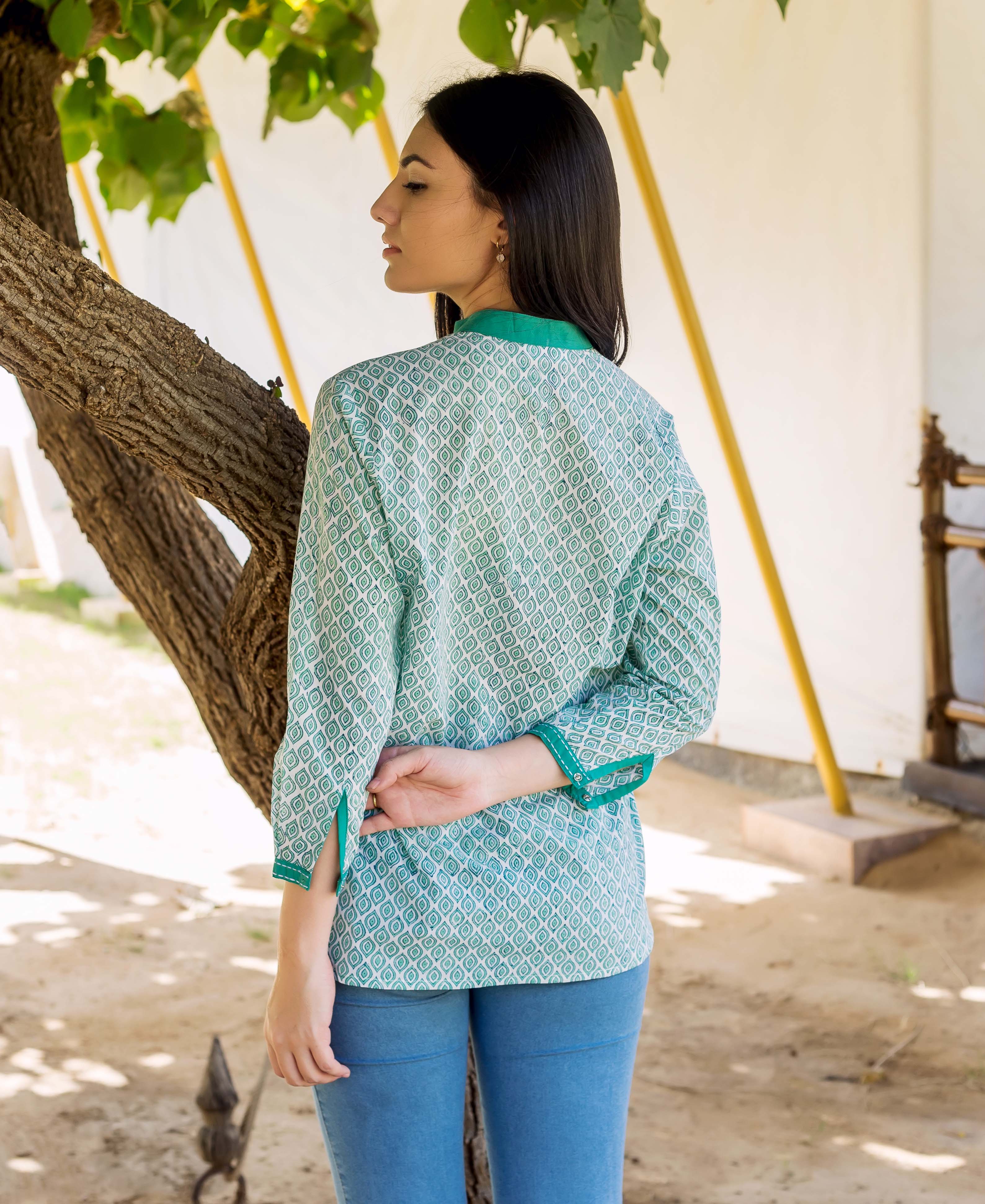 Model from back wearing white and green hand block printed top with diamond print.