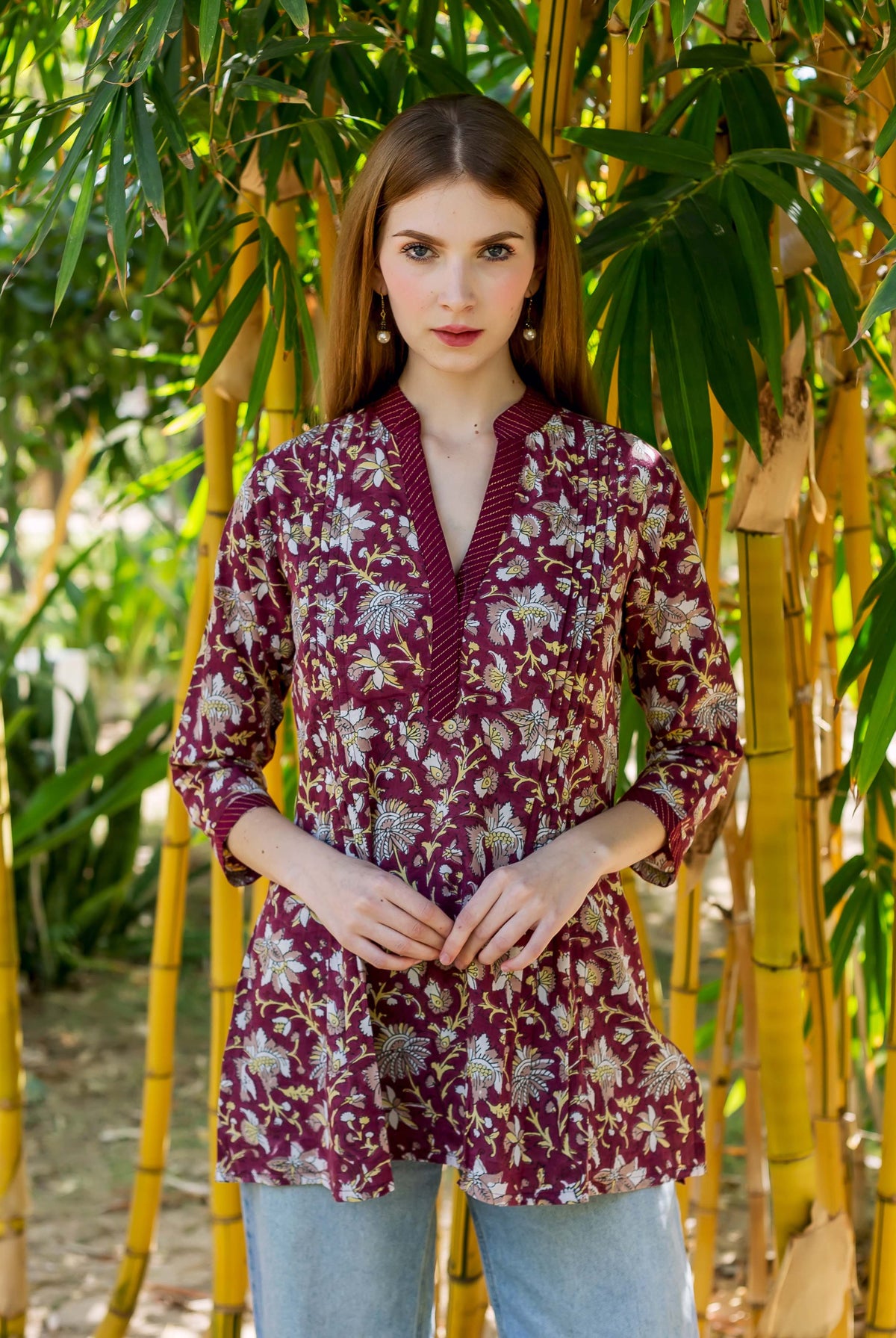 Front-facing model in a wine red hand-block-printed ethnic floral Oivia tunic top.