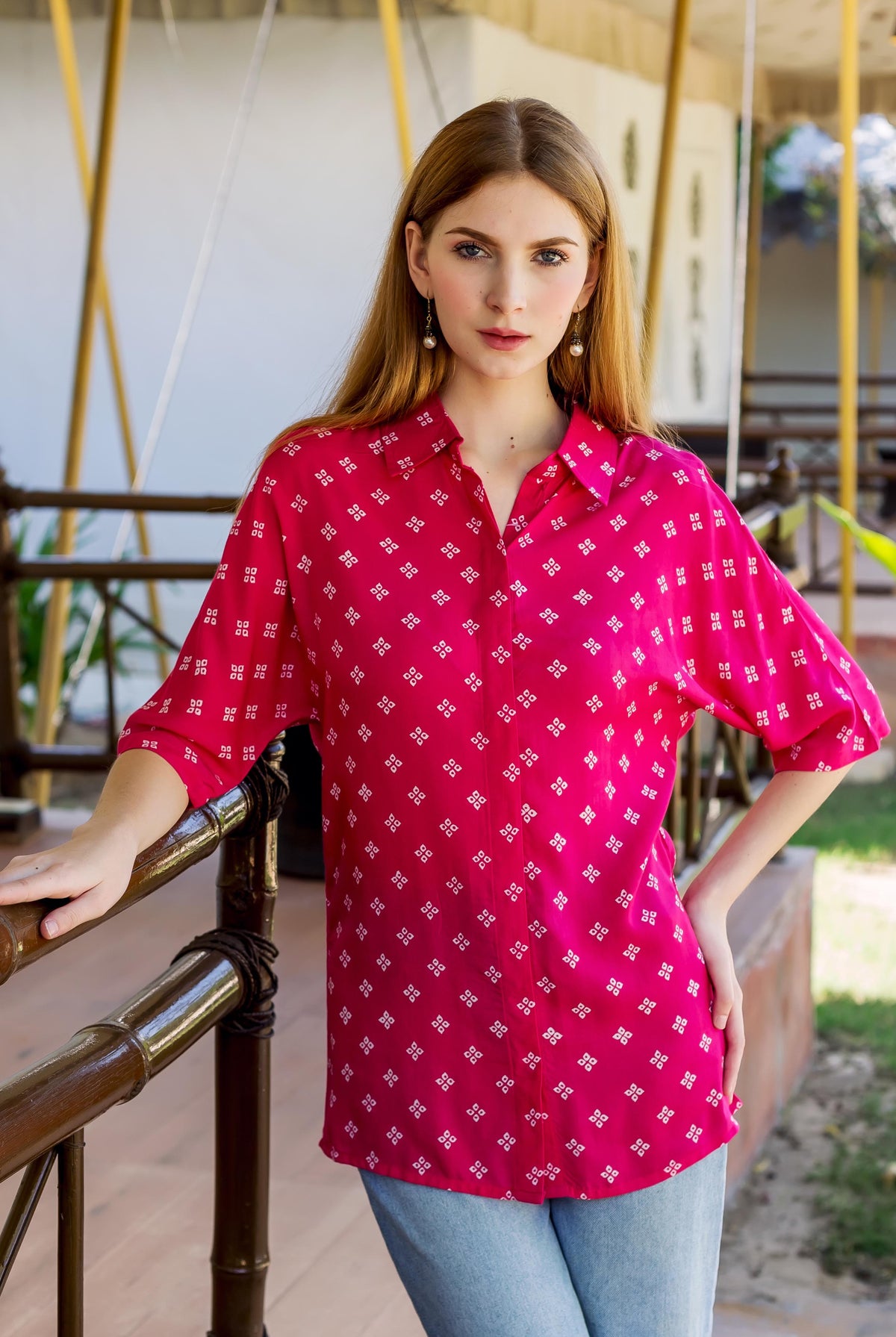 A model wearing a magenta bandhej printed button down shirt.