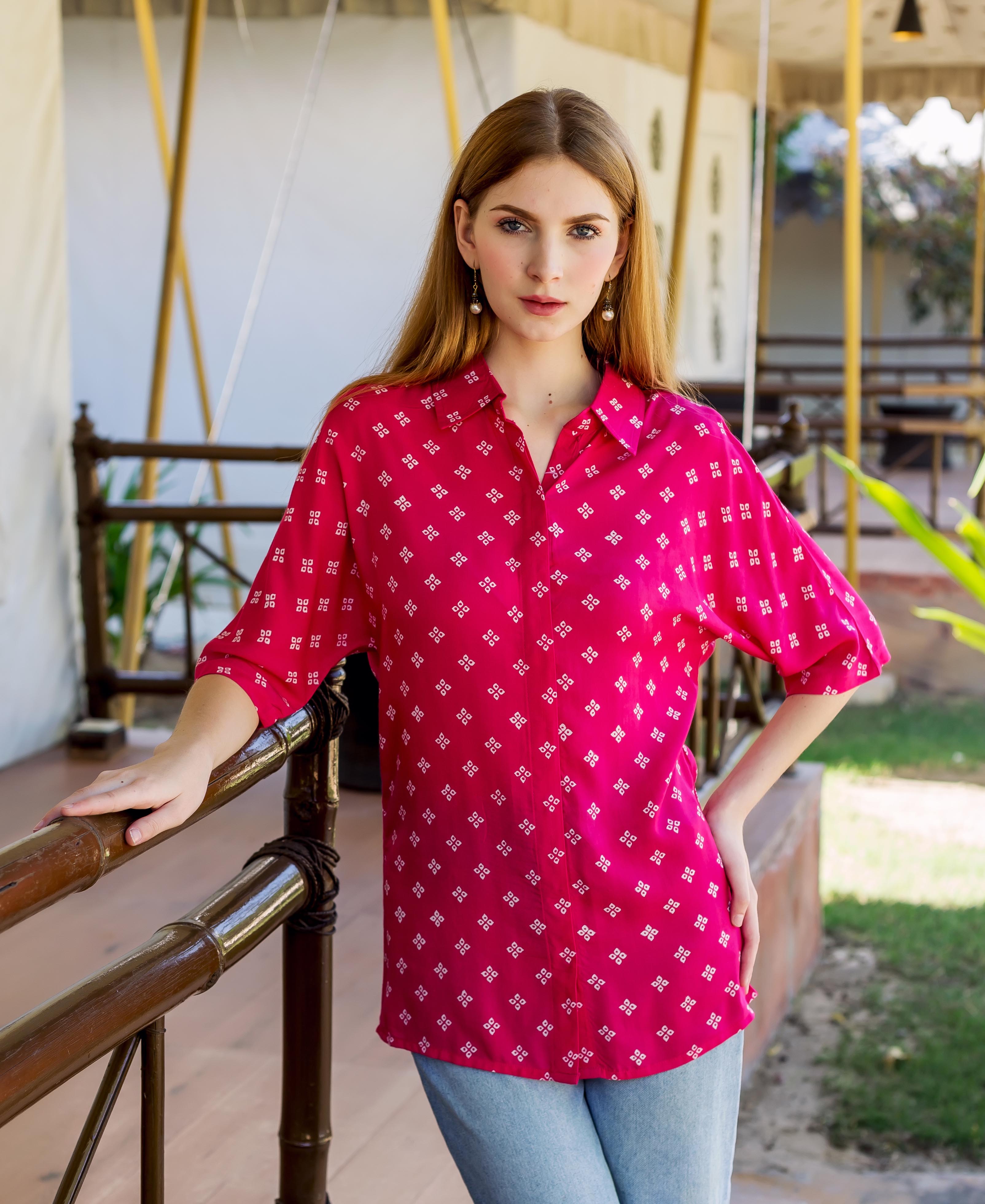 A model wearing a magenta bandhej printed button down shirt.