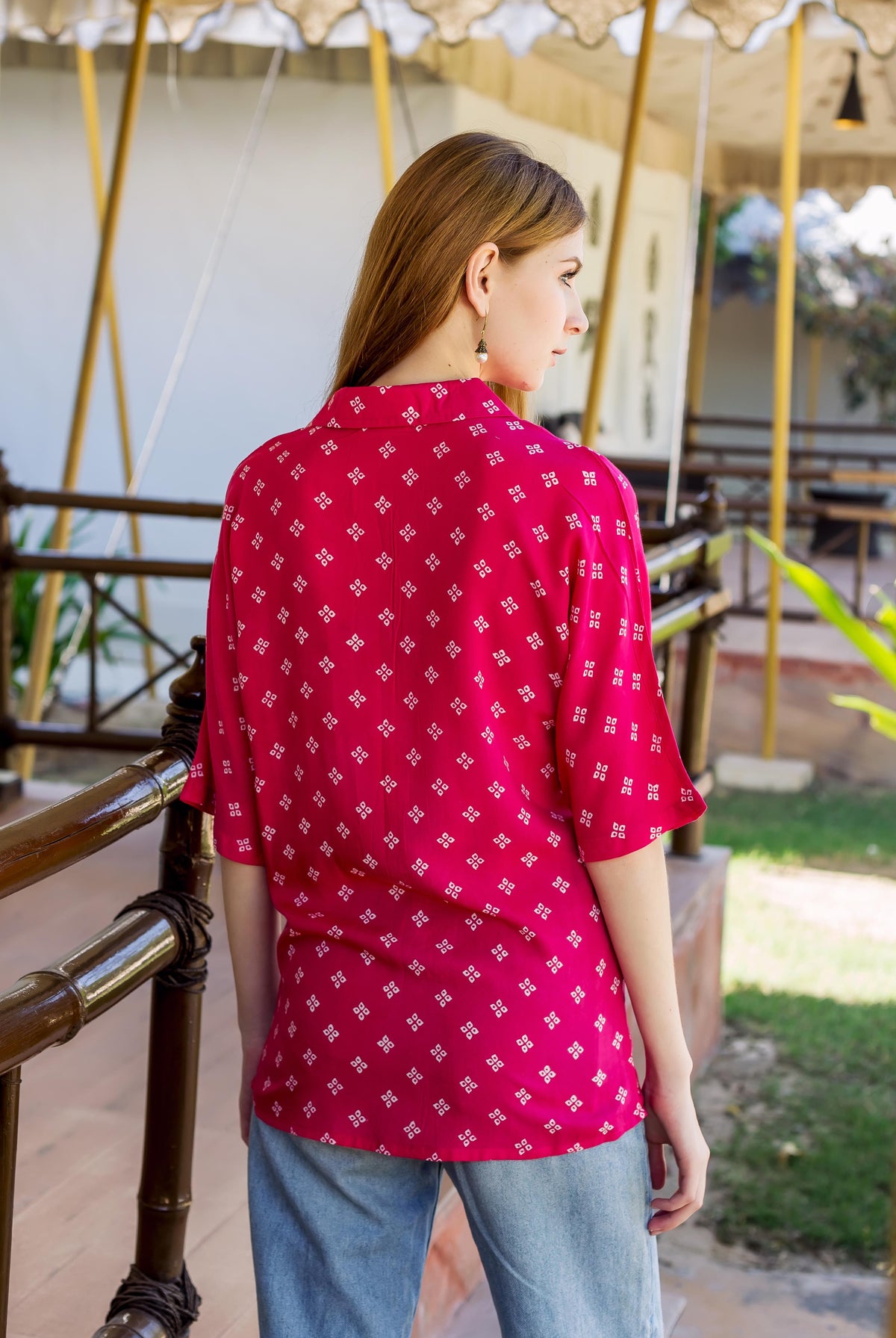 Magenta bandhej printed button down shirt on model from behind, showing white square pattern.