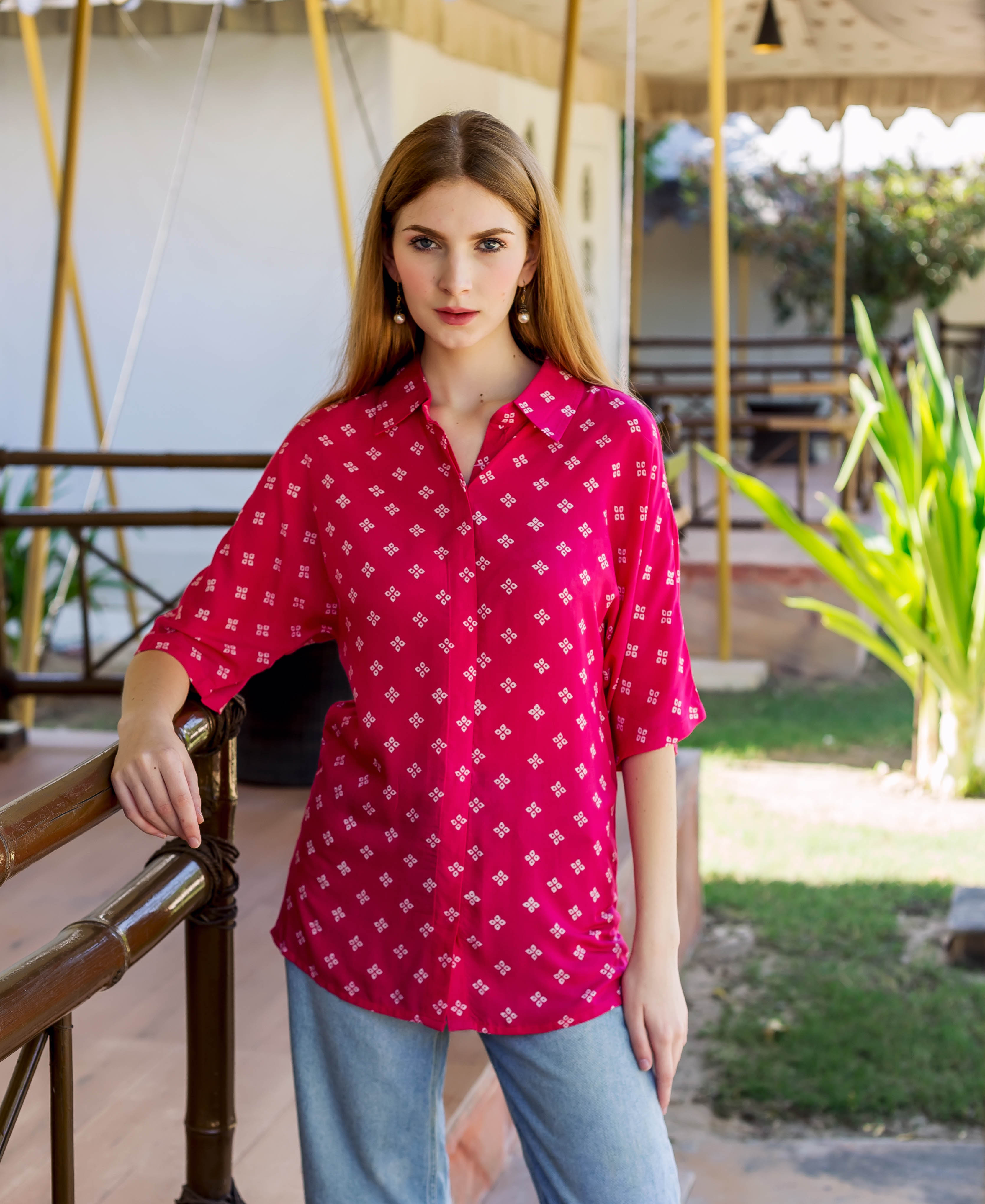 Magenta Bandhej printed button-down shirt on a standing model with white geometric patterns.