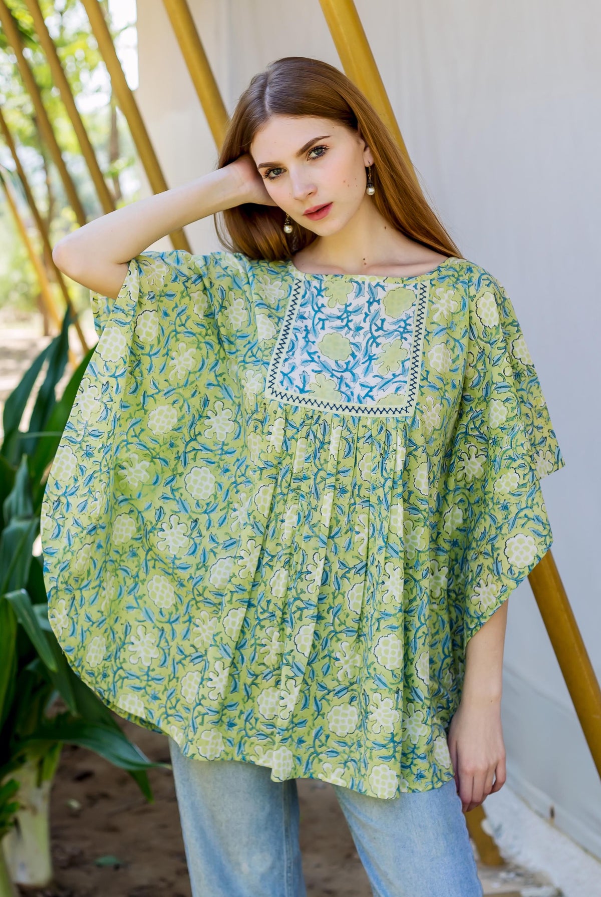 Model in a lime green hand block printed kaftan top with blue and white floral pattern.