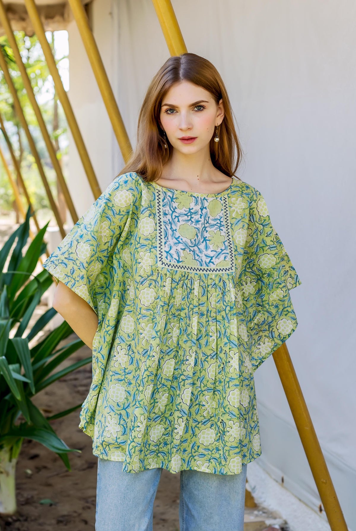 Model wearing a lime green hand block printed kaftan top featuring blue and light green florals.