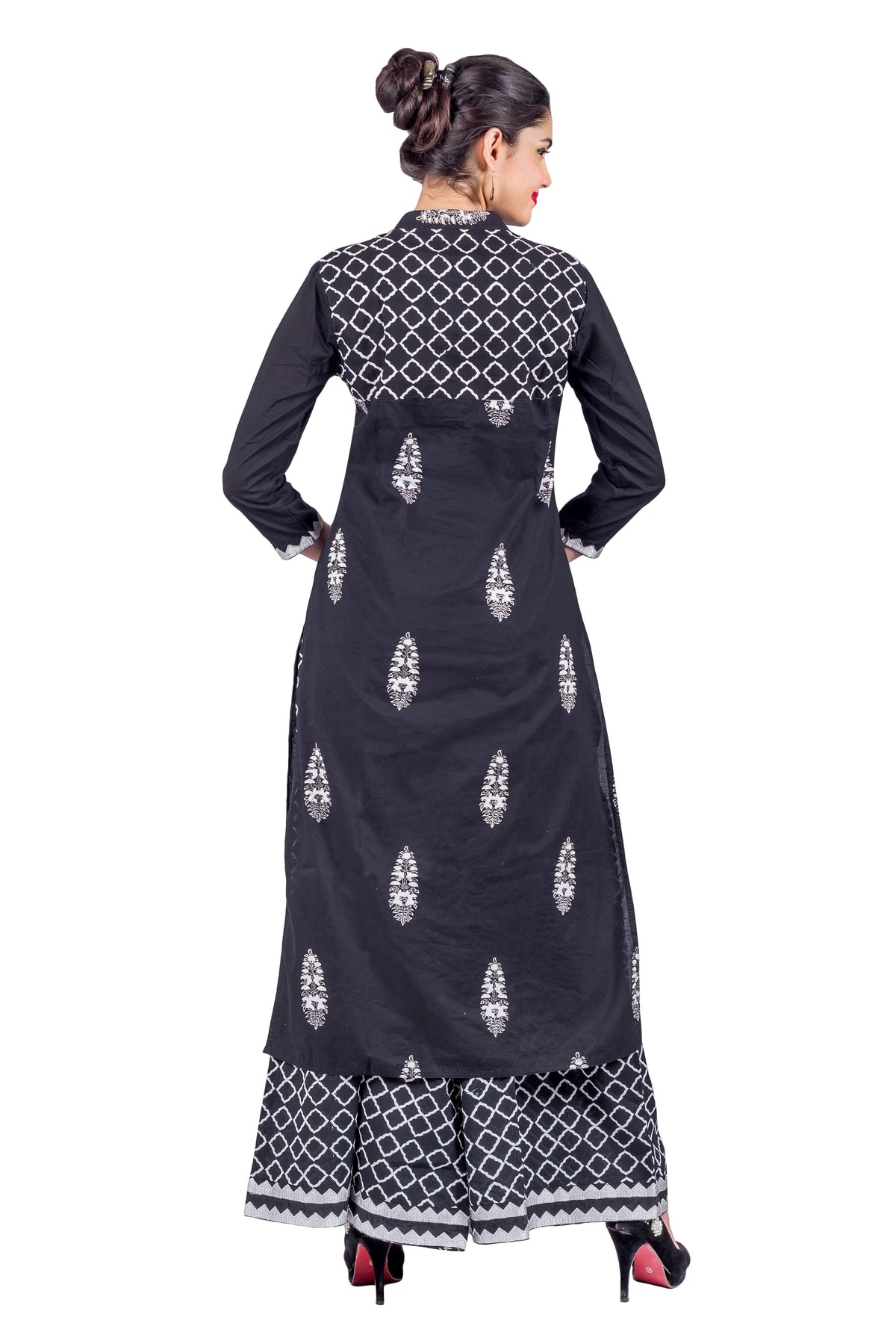 Back view of model wearing black embroidered kurta with geometric yoke and matching printed palazzo.