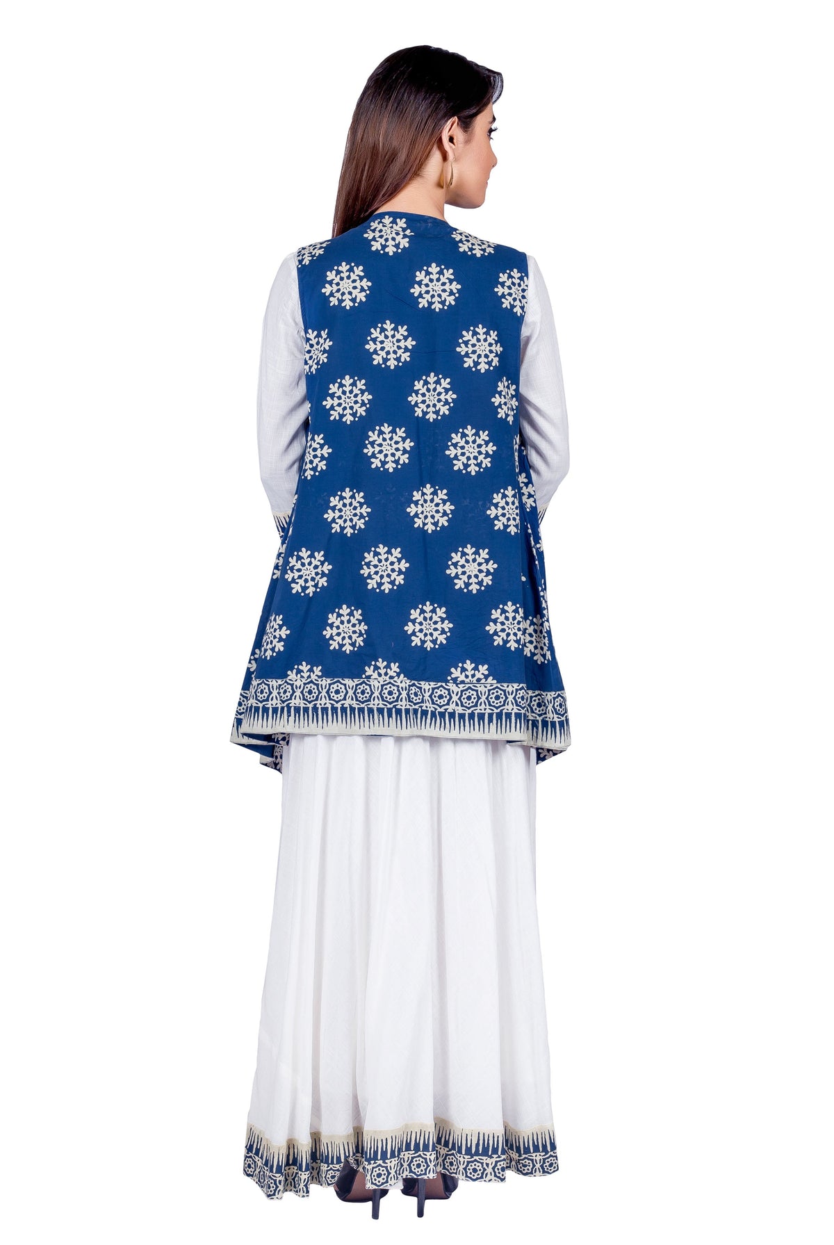 Back view: model in white maxi dress and blue hand-block-printed shrug with white snowflake print.