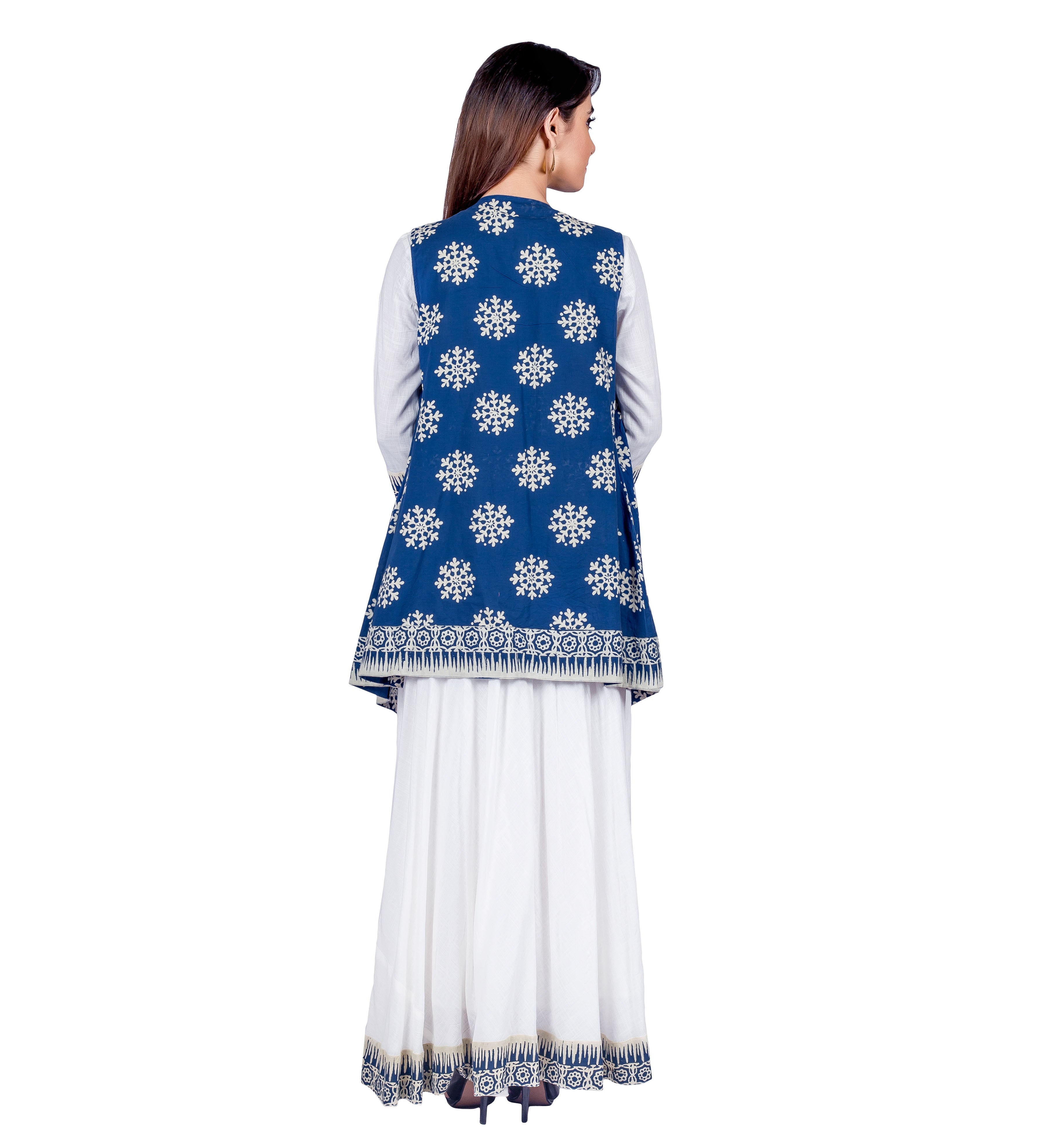 Back view: model in white maxi dress and blue hand-block-printed shrug with white snowflake print.