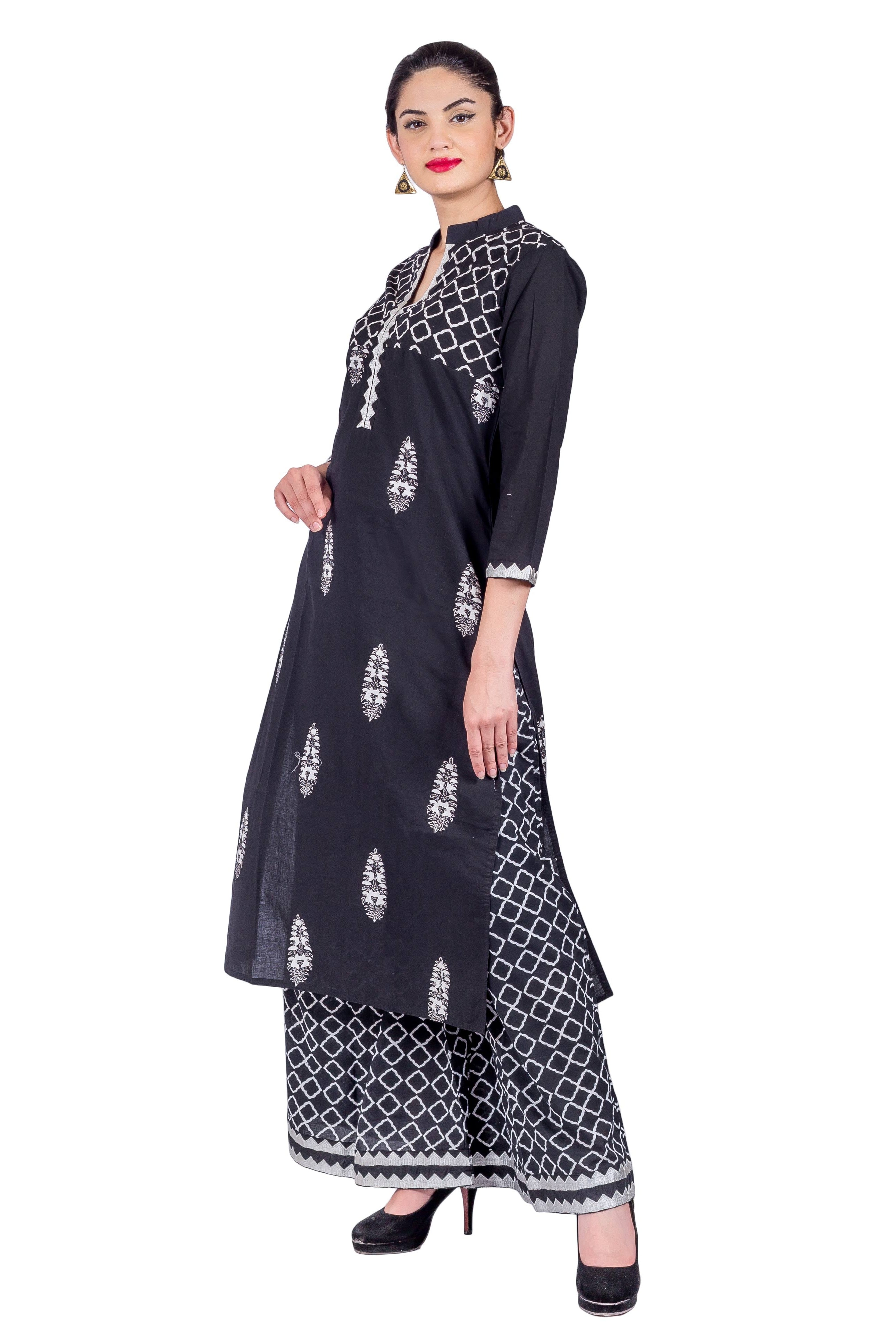 Woman modeling black mandarin neck kurta with white prints and geometric palazzo pants, angled.