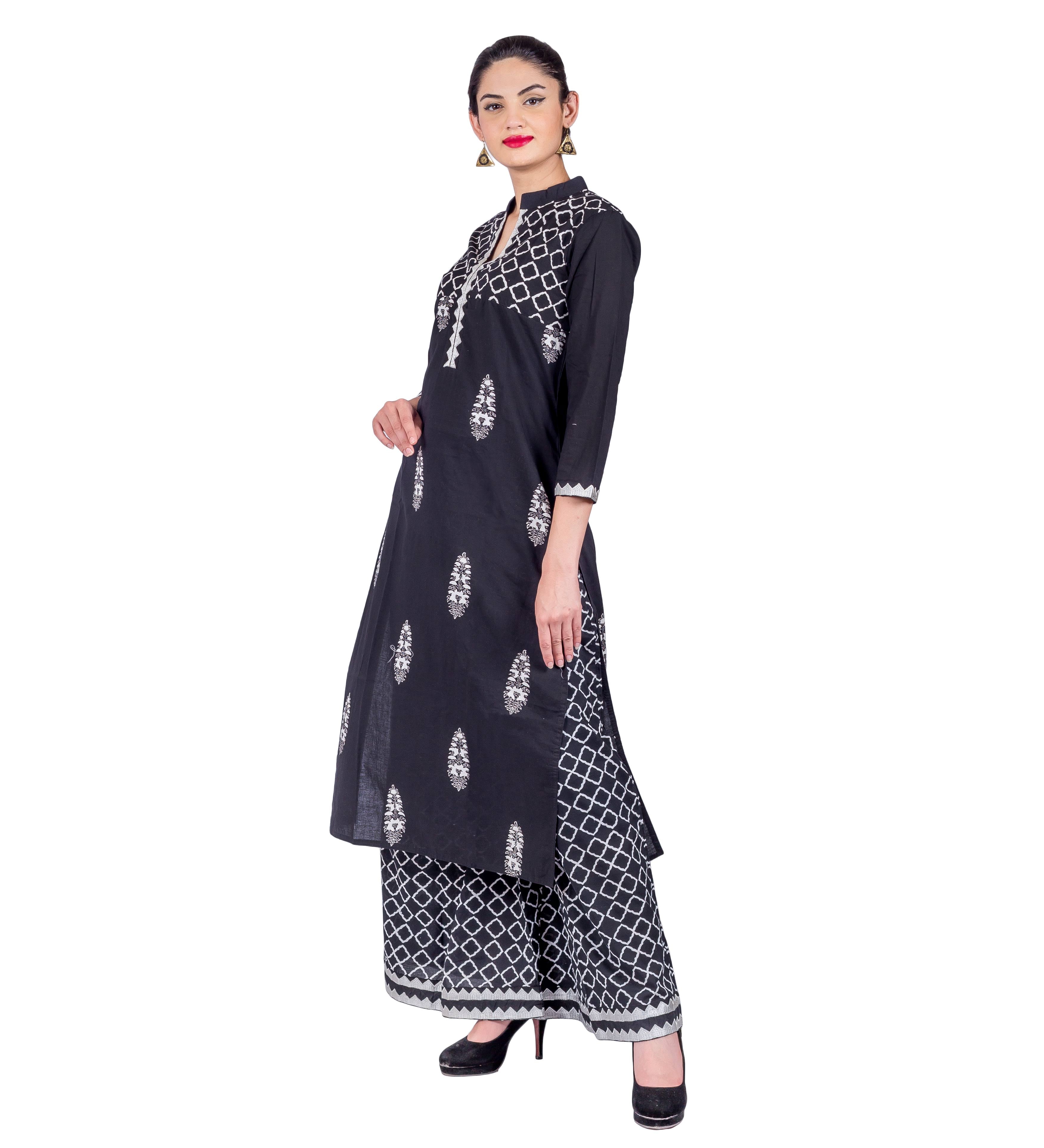 Woman modeling black mandarin neck kurta with white prints and geometric palazzo pants, angled.