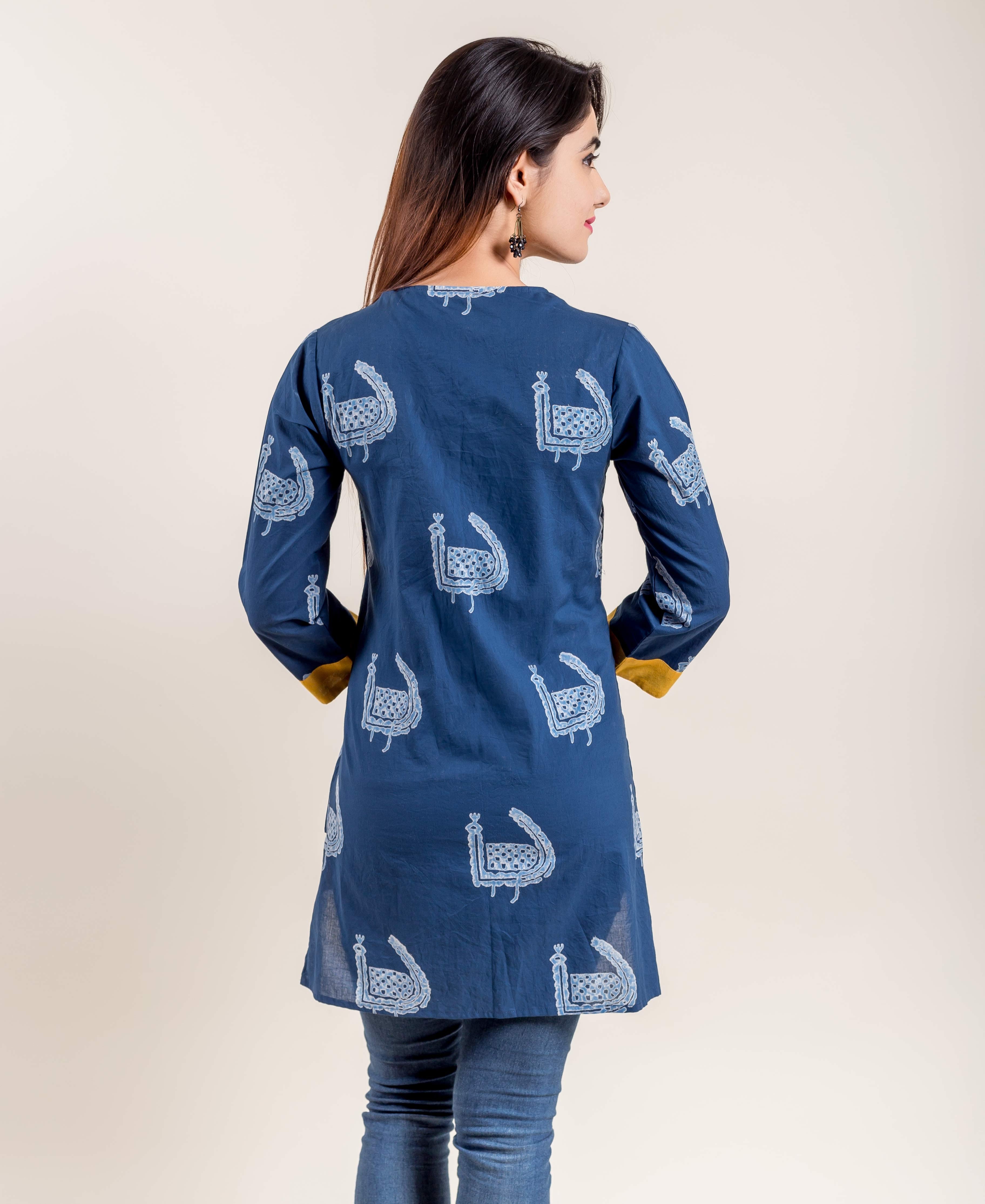 Model from back wearing indigo short kurti with white block print and yellow cuffs.