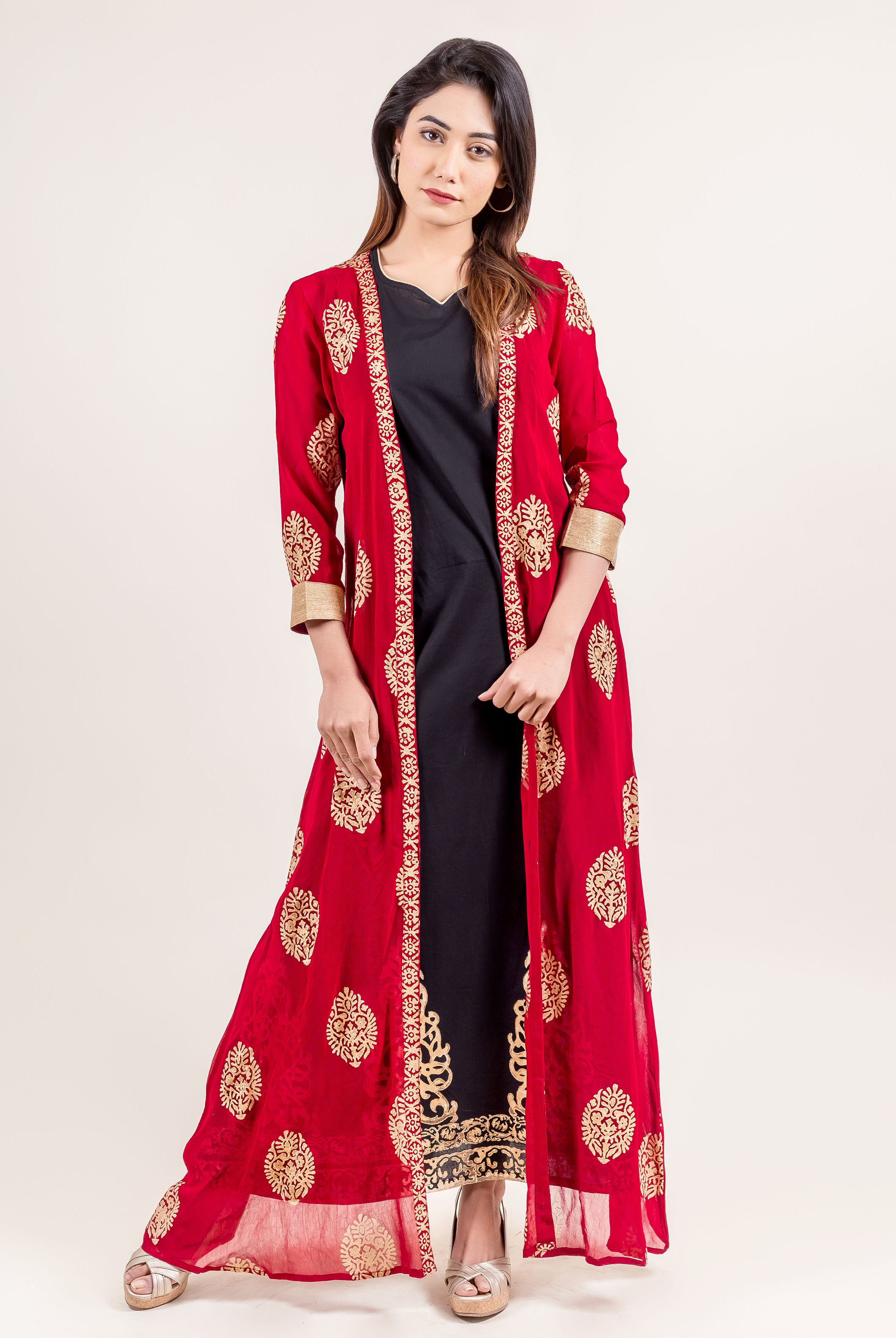 Full-length model wearing a red gold-printed jacket style long dress over a black inner.