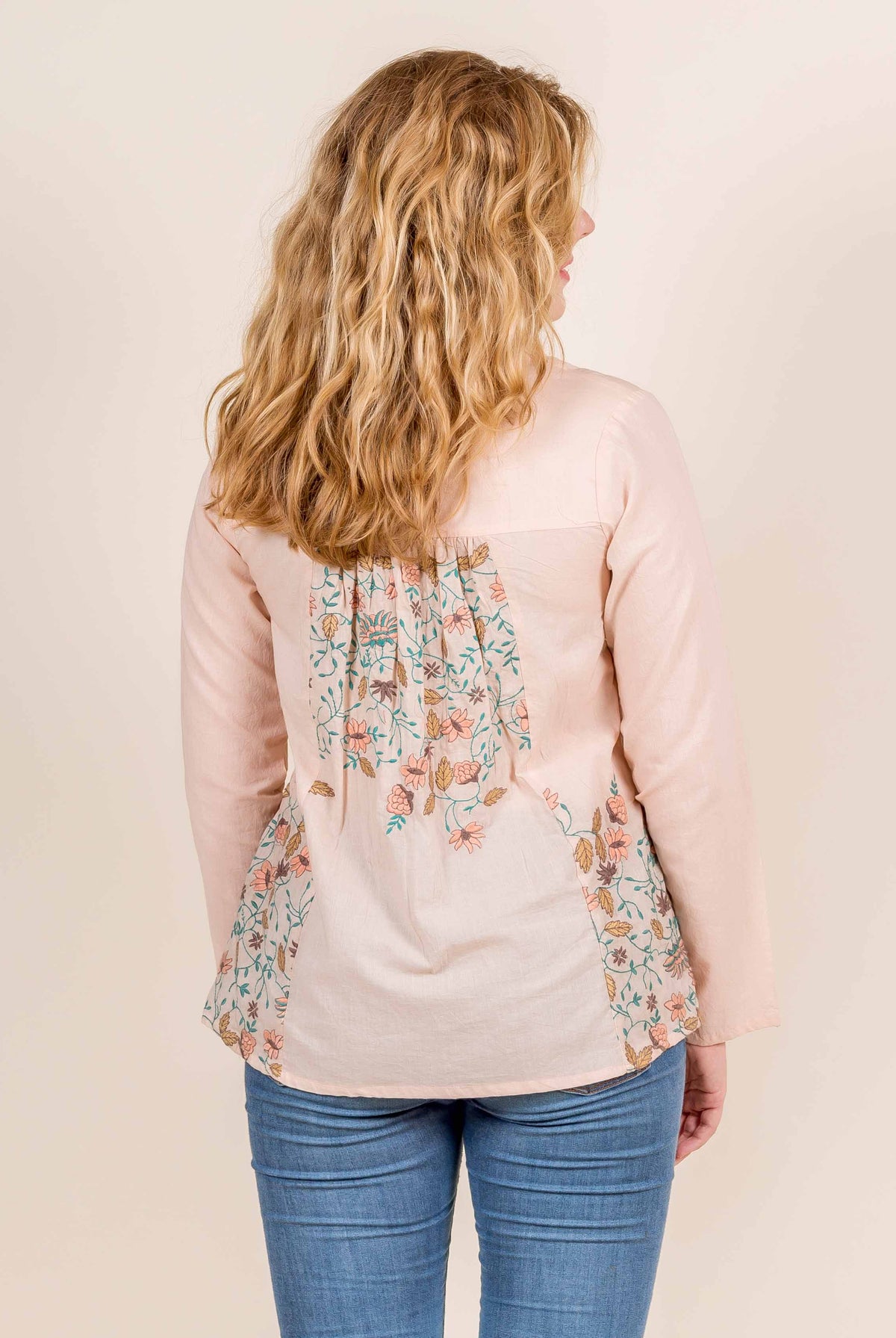 Back view of model in pink multi-coloured hand-block-printed floral short top.