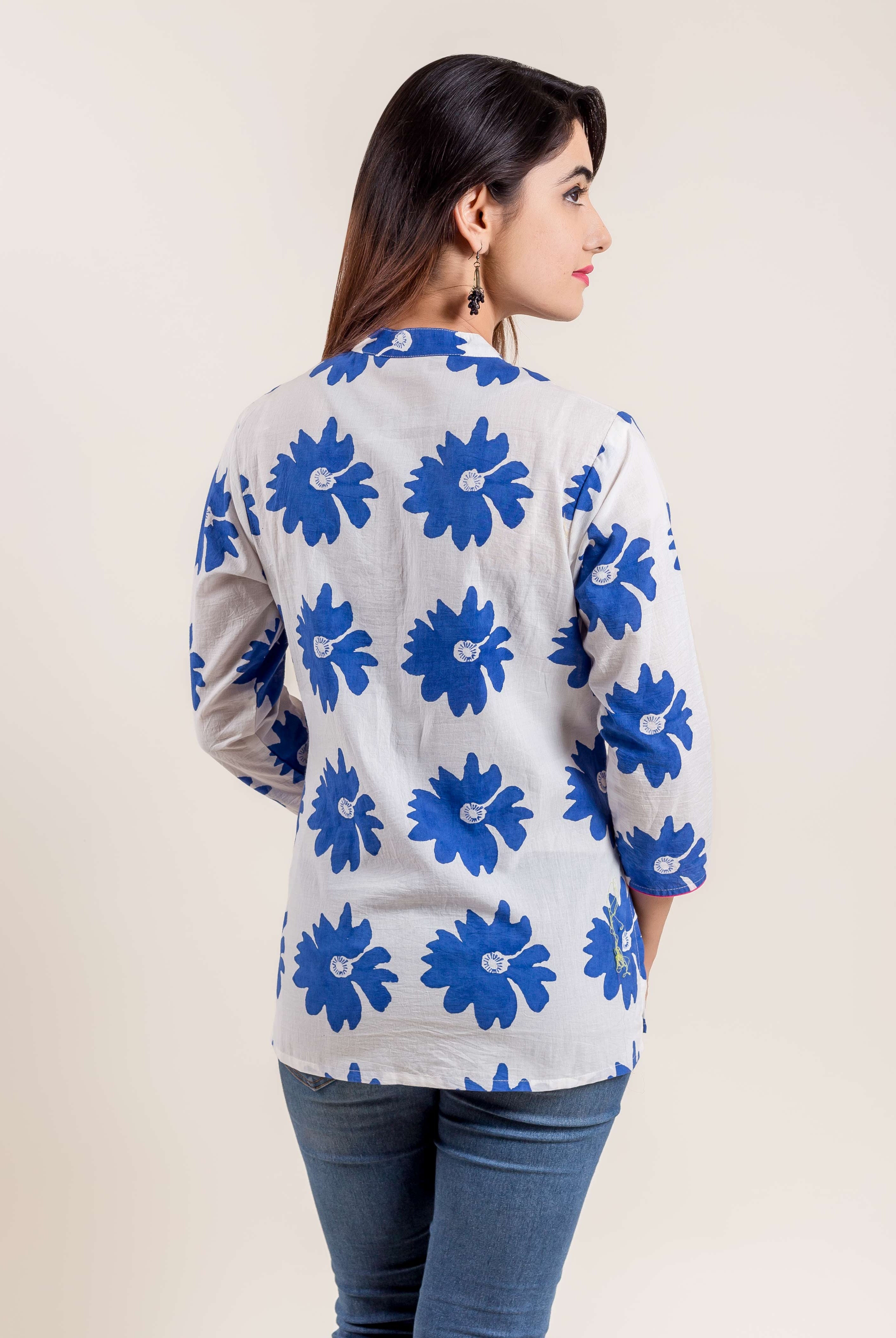Model in blue and white floral hand block printed ethnic short kurti, back view.