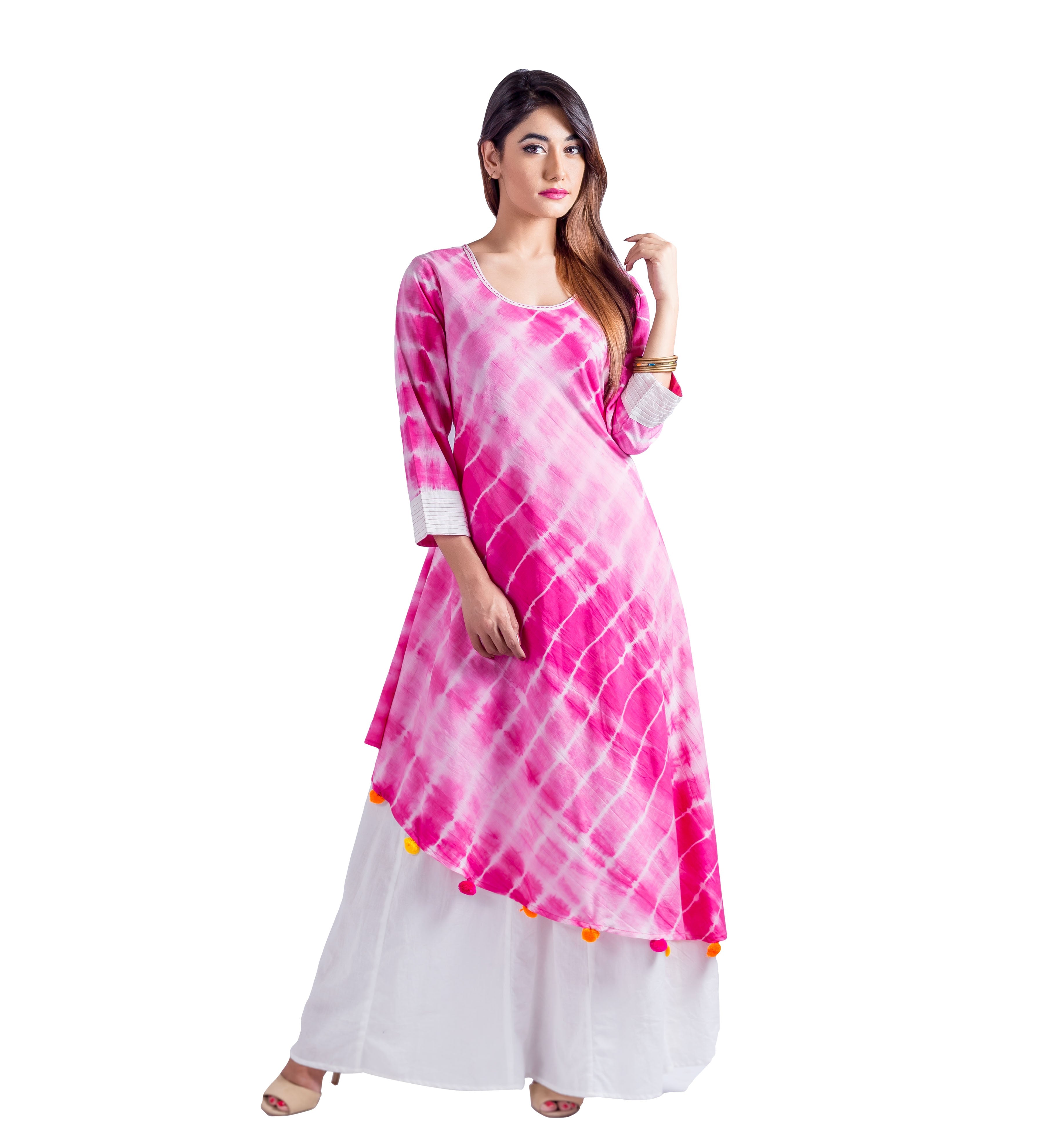 Full-length model in fuchsia and white tie-dye asymmetric kurta, white palazzos, with pom-poms.