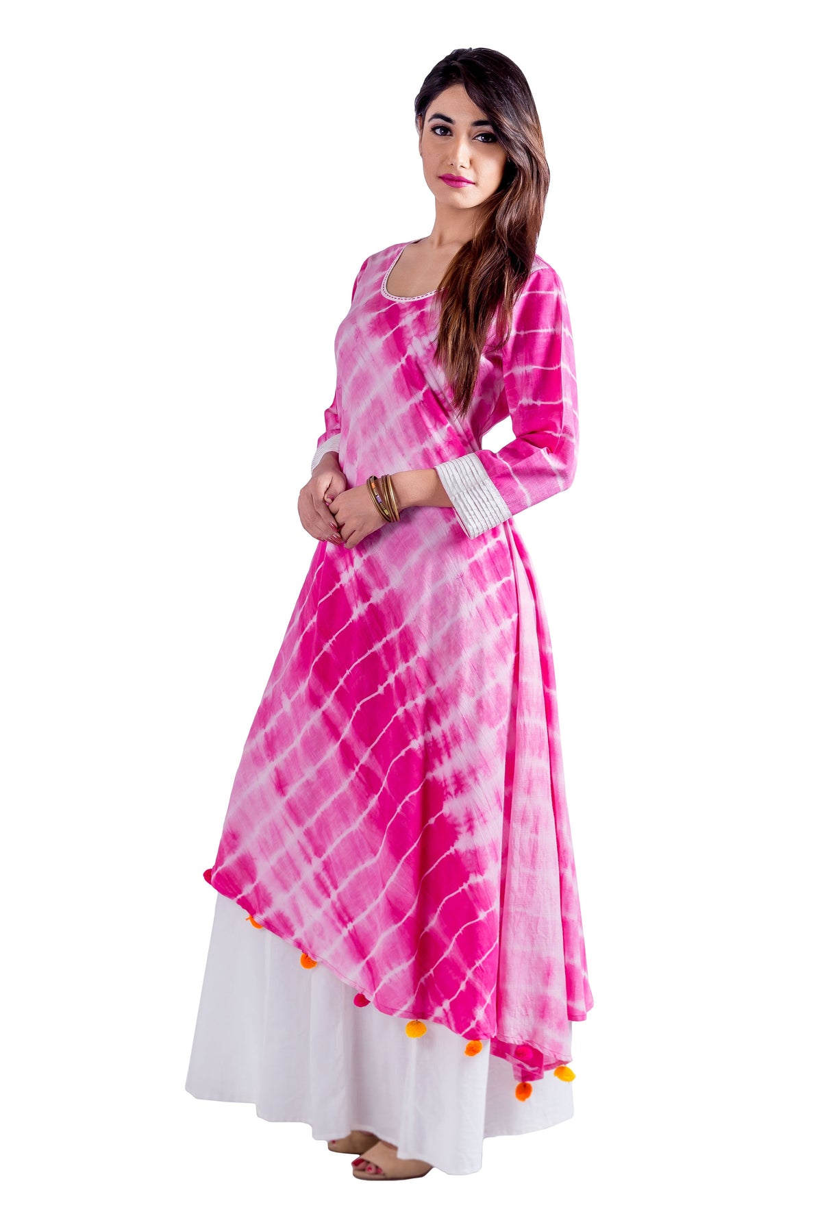 Model in fuchsia and white tie-dye asymmetrical Indo Western dress with orange pom-poms.